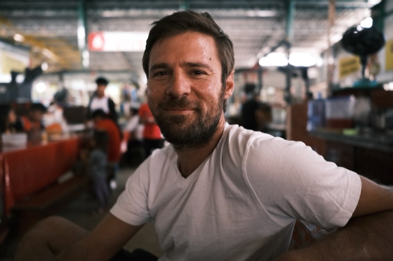 Iso Rabins smiling at a bustling market